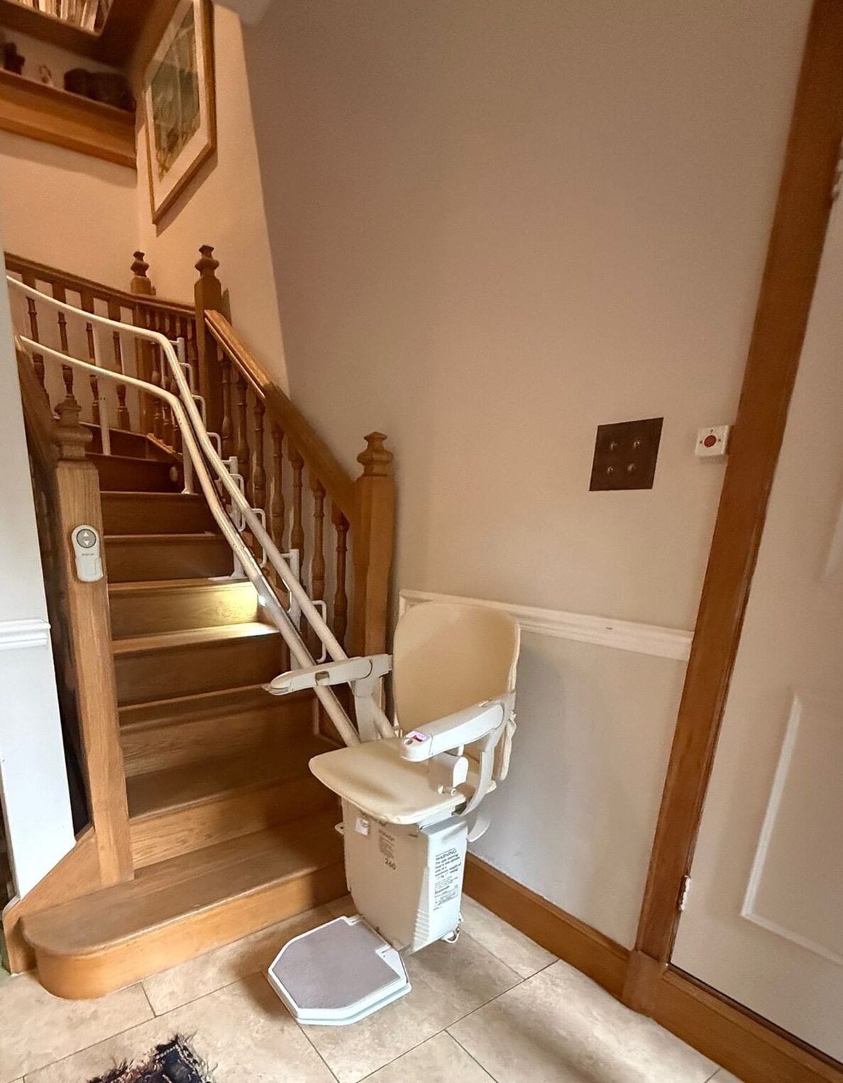 Stannah 260 Wooden staircase with installed stairlift chair indoors